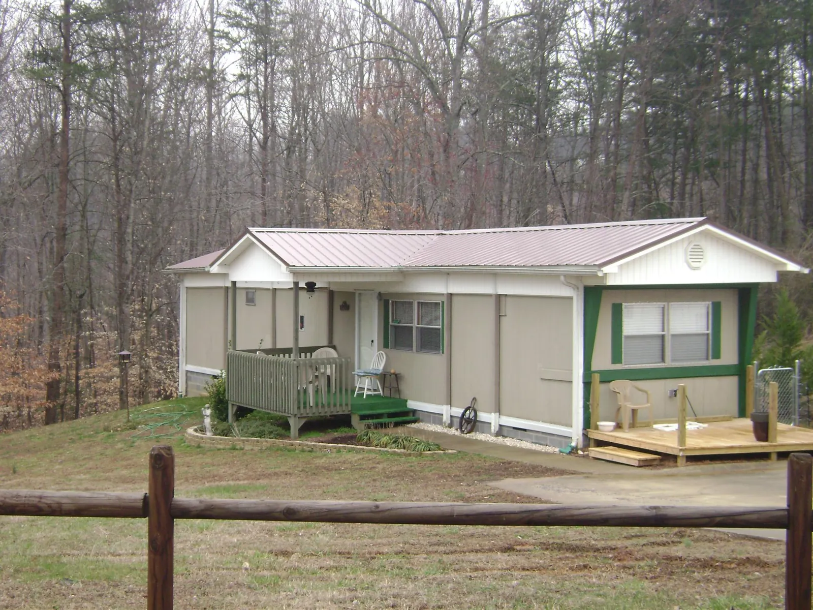 Mauve metal roof on a manufactured home with a new front deck in Stockport